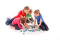 Kids of different age solving jigsaw puzzle together Royalty Free Stock Photo
