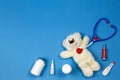 Kids doctor concept. Teddy bear, stethoscope, medical toy kit and medications on blue background. Top view Royalty Free Stock Photo