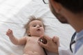 Kids doctor examining cute baby, applying stethoscope to chest Royalty Free Stock Photo