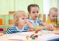 Kids doing arts and crafts in day care centre Royalty Free Stock Photo