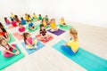 Kids doing butterfly stretch with female coach Royalty Free Stock Photo