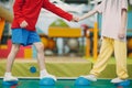 Kids doing massage hedgehog for foot legs exercises in gym at kindergarten or elementary school. Children meet sport and Royalty Free Stock Photo