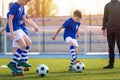 Kids Doing Sports Outdoor. Soccer Training for Children. Boys Training with Youth Coach