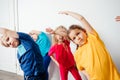 Kids doing stretching exercises before gymnastic training Royalty Free Stock Photo