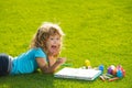 Kids drawing. Child boy enjoying art and craft drawing in backyard or spring park. Children drawing draw with pencils