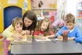 Kids and Educator Playing at Kindergarten Royalty Free Stock Photo