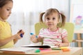 Kids drawing in kindergaten. Children paint in nursery. Preschooler with pen at home. Creative toddlers. Royalty Free Stock Photo