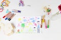 Kids drawing of multi-racial Family and colored pencils on wooden table Royalty Free Stock Photo