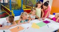 Kids drawing together with tutor at hobby group Royalty Free Stock Photo