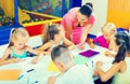 Kids drawing together with tutor at hobby group Royalty Free Stock Photo