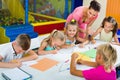 Kids drawing together with tutor at hobby group Royalty Free Stock Photo