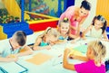 Kids drawing together with tutor at hobby group Royalty Free Stock Photo