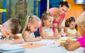 Kids drawing together with tutor at hobby group Royalty Free Stock Photo