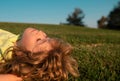 Kids dreaming. Child boy enjoying on grass field and dreaming. Kids play on summer field. Royalty Free Stock Photo