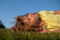 Kids dreaming. Happy little boy laying on grass. Kids exploring nature, summertime. Royalty Free Stock Photo