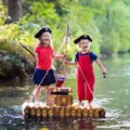 Kids playing pirate adventure on wooden raft Royalty Free Stock Photo