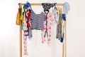 Kids dressing closet with clothes arranged on hangers.p