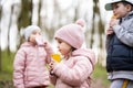 Kids drink juice using straws at forest, happy child moments Royalty Free Stock Photo