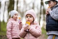 Kids drink juice using straws at forest, happy child moments Royalty Free Stock Photo