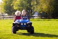 Kids driving electric toy car. Outdoor toys Royalty Free Stock Photo