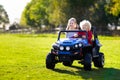 Kids driving electric toy car. Outdoor toys Royalty Free Stock Photo