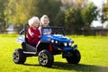 Kids driving electric toy car. Outdoor toys Royalty Free Stock Photo