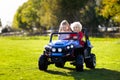 Kids driving electric toy car. Outdoor toys Royalty Free Stock Photo