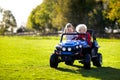 Kids driving electric toy car. Outdoor toys Royalty Free Stock Photo