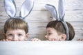 Kids on Easter egg hunt in blooming spring garden. Children searching for colorful eggs in flower meadow. Toddler boy and his brot Royalty Free Stock Photo