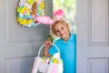 Kids Easter egg hunt. Child and eggs, bunny ears Royalty Free Stock Photo
