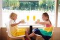 Kids eat cake at restaurant. Boy and girl in cafe Royalty Free Stock Photo