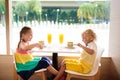 Kids eat cake at restaurant. Boy and girl in cafe Royalty Free Stock Photo