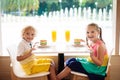 Kids eat cake at restaurant. Boy and girl in cafe Royalty Free Stock Photo