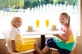 Kids eat cake at restaurant. Boy and girl in cafe Royalty Free Stock Photo