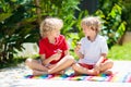 Kids eat ice cream in garden. Summer fun