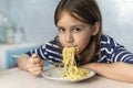 Kids eat pasta. Healthy lunch for children. Toddler kid eating spaghetti Bolognese in blue kitchen at home. Preschooler child try Royalty Free Stock Photo