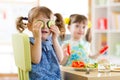 Kids eating healthy food in kindergarten or at home