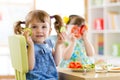 Kids eating healthy food in kindergarten or at home Royalty Free Stock Photo