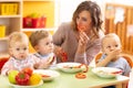 Kids eating healthy food in kindergarten, nursery or at home Royalty Free Stock Photo