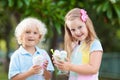 Kids eating ice cream. Child with fruit dessert.