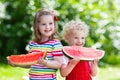 Kids eating watermelon in the garden Royalty Free Stock Photo