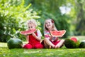 Kids eating watermelon in the garden Royalty Free Stock Photo