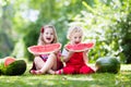 Kids eating watermelon in the garden Royalty Free Stock Photo