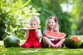 Kids eating watermelon in the garden Royalty Free Stock Photo