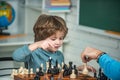 Kids educational games, early development. Boy kid playing chess at home. Games and activities for children. Family