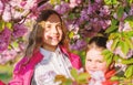 Kids enjoying cherry blossom. Pink is our favorite. Children enjoy spring garden. Sakura garden. Sisters walk park Royalty Free Stock Photo