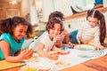 Kids enjoying painting with their fingers during the class