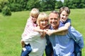 Kids enjoying piggy ride on parents back Royalty Free Stock Photo