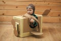 Kids enyoj happy day. Brave dreamer boy playing with a cardboard airplane Royalty Free Stock Photo