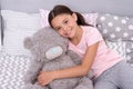 Kids evening routines. Favorite toy. Girl child hug teddy bear in her bedroom. Pleasant time in cozy bedroom. Girl kid